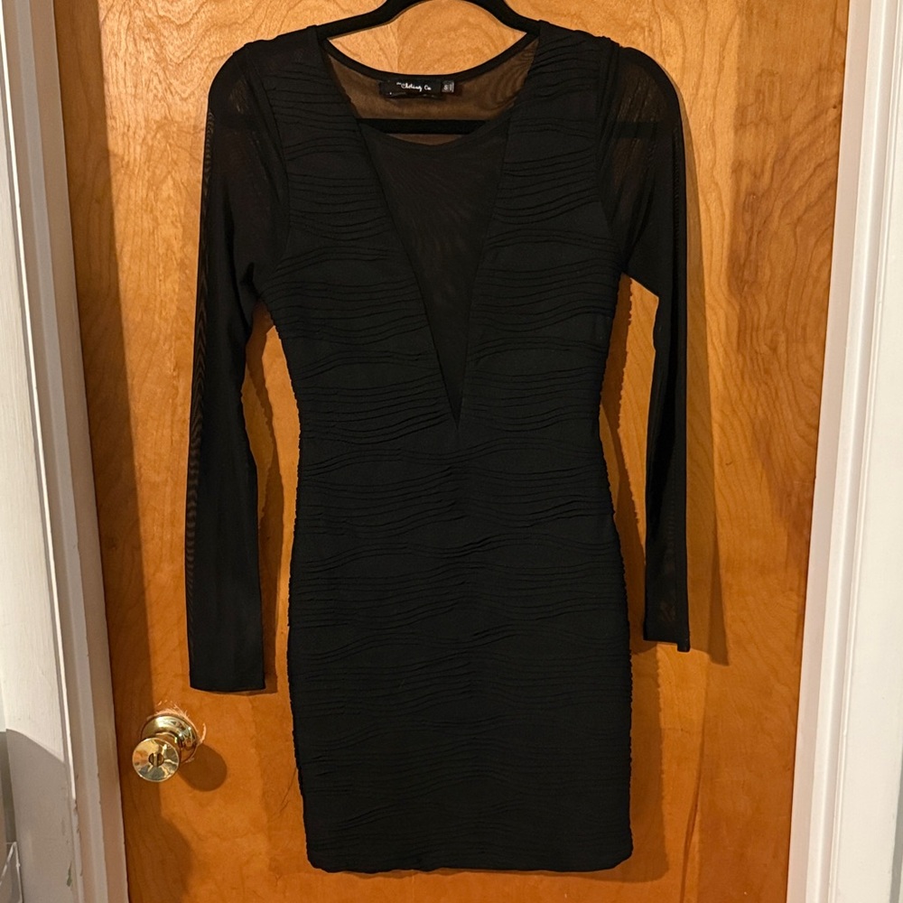 Little black dress with mesh sleeves and deep v-neck
